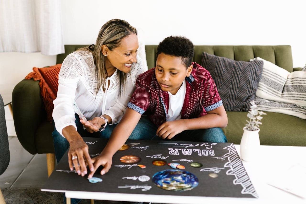 Teenager with Mother Preparing Solar System Project